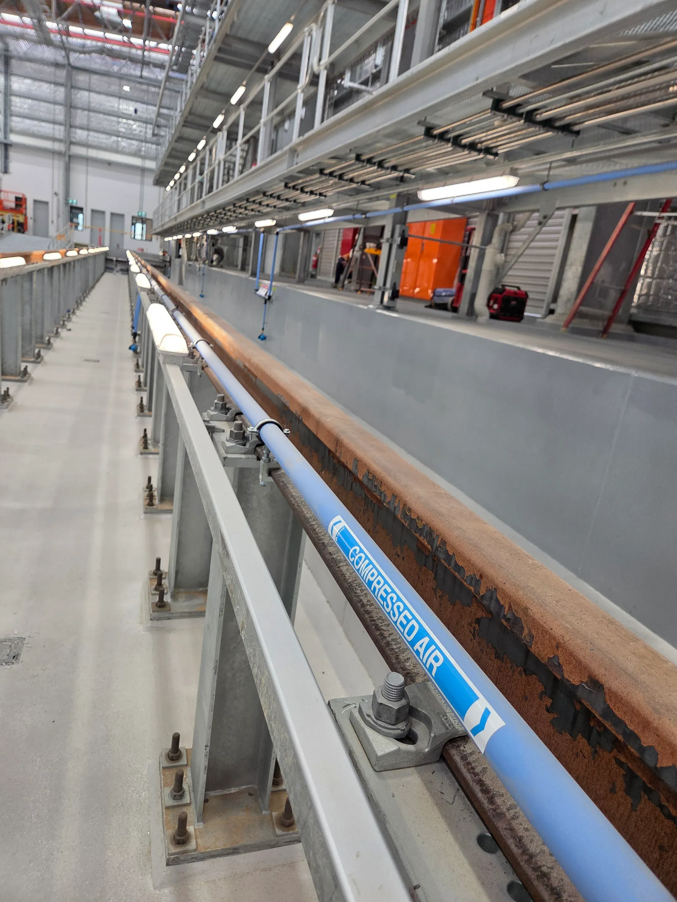 Compressed air pipework installed along a commercial walkway