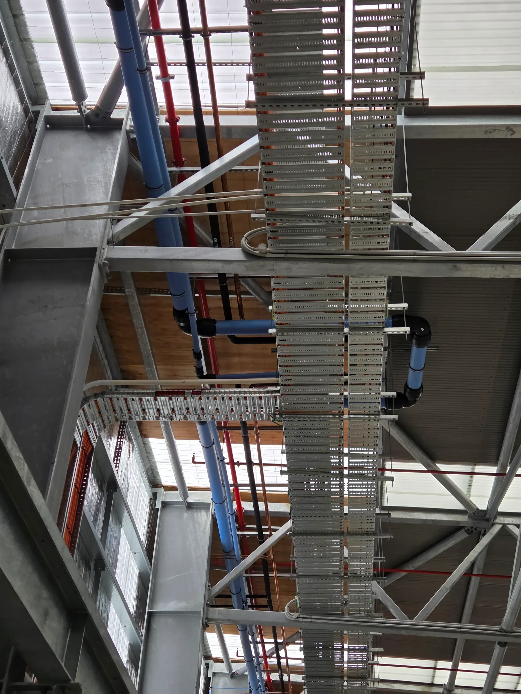 Suspended pipework installed across a commercial construction area